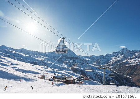 Beautiful view of Gornergrat, Zermatt, Matterhorn ski resort in Switzerland with cable chair lift transportation. Ski lifts in Switzerland. Winter holidays. Beautiful view of Gornergrat, Zermatt, Matterhorn ski resort in Switzerland with cable chair lift transportation. Ski lifts in Switzerland. Winter holidays. 101571663