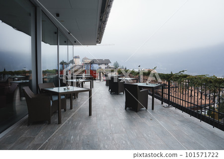 Chairs and tables arranged at outdoor restaurant in luxury hotel, luxury travel concept Chairs and tables arranged at outdoor restaurant in luxury hotel, luxury travel concept 101571722