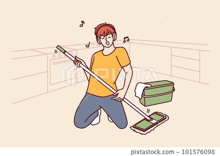 Man cleaning floor with mop stands in pose of rock musician imagining that is holding guitar 101576098