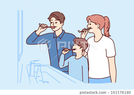 Family brushes teeth together standing in bathroom near mirror to teach boy hygiene procedures 101576180