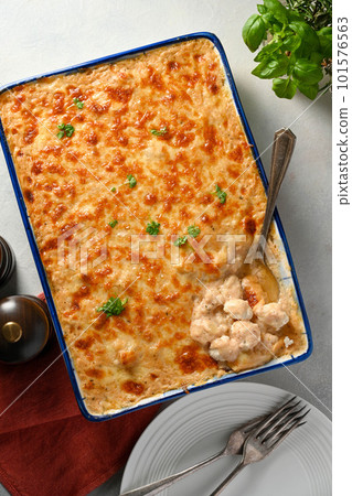 Cauliflower with bechamel sauce and cheese in ceramic baking dish, top view. Cauliflower with bechamel sauce and cheese in ceramic baking dish, top view. 101576563