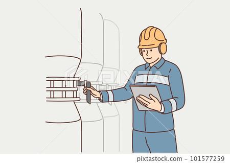 Man working at factory holds electronic tablet standing near industrial equipment and tanks 101577259