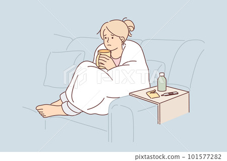 Woman sick with flu wrapped in blanket sits on couch and drinks hot decoction of herbs Woman sick with flu wrapped in blanket sits on couch and drinks hot decoction of herbs 101577282