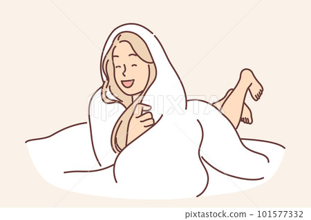 Laughing woman wrapped in blanket lies on bed not wanting to get up and go to work or college 101577332
