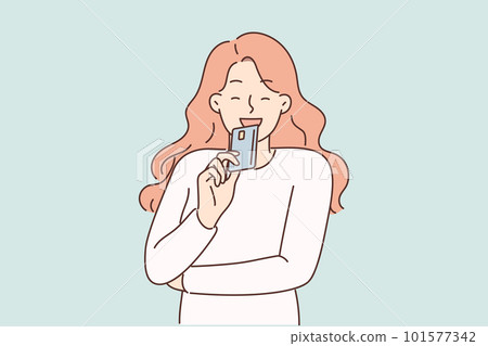 Woman brings credit card to face and smiles planning to make online purchase or pay for shopping Woman brings credit card to face and smiles planning to make online purchase or pay for shopping 101577342