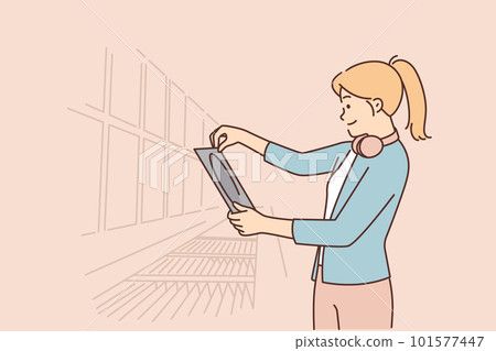 Woman stands in music store and looks at vinyl record of rare acoustic concert by favorite band 101577447