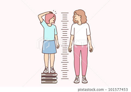 Little girl stands on books measuring growth and wants to compete with older sister 101577453
