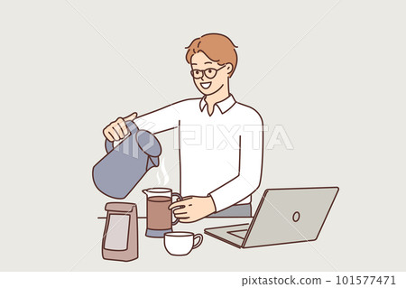 Man office worker brews coffee zero hot water from kettle at table with laptop 101577471