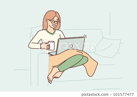 Woman sits in armchair with laptop on lap and drinks coffee enjoying relaxation in cozy home Woman sits in armchair with laptop on lap and drinks coffee enjoying relaxation in cozy home 101577477