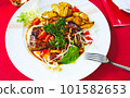 Grilled beef steak with chanterelles and vegetables on plate, top view 101582653