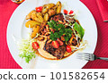 Grilled beef steak with chanterelles and vegetables on plate, top view 101582654