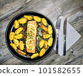 Fried salmon fillet with potato wedges on plate, top view 101582655