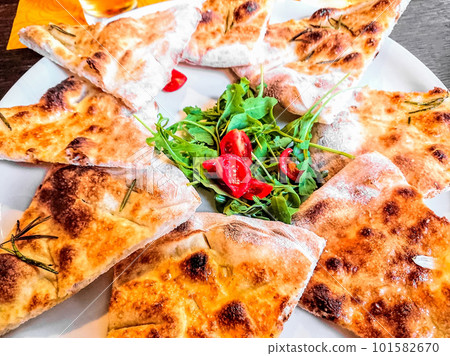 Pizza bread with arugula and tomatoes italian style, top view Pizza bread with arugula and tomatoes italian style, top view 101582670