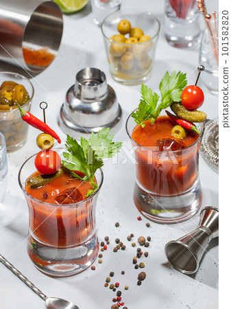 Bloody mary cocktail glasses with bar shaker,jigger,spoon on light  101582820