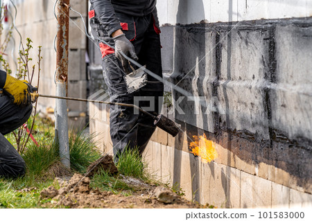 installation of protective waterproofing on the foundation and walls of the building. warmed by an open fire 101583000