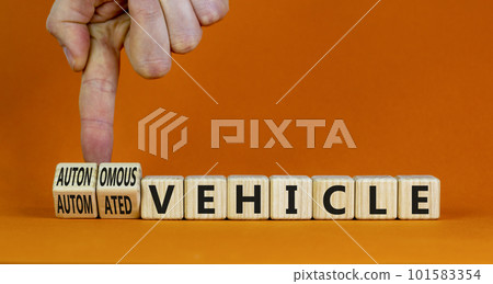 Autonomous or automated vehicle symbol. Businessman turn cubes changes words Automated vehicle to Autonomous vehicle. Orange background. Business Autonomous or automated vehicle concept, copy space. 101583354