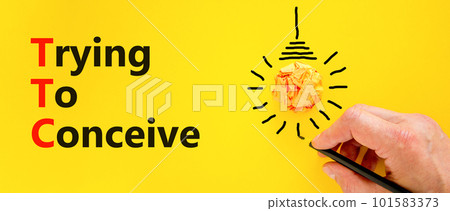 TTC trying to conceive symbol. Concept words TTC trying to conceive on yellow paper on a beautiful yellow background. Orange light bulb icon. Medical and TTC trying to conceive concept. Copy space. TTC trying to conceive symbol. Concept words TTC trying to conceive on yellow paper on a beautiful yellow background. Orange light bulb icon. Medical and TTC trying to conceive concept. Copy space. 101583373