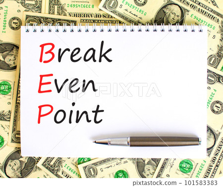BEP break even point symbol. Concept words BEP break even point on white note on a beautiful background from dollar bills. Pen. Business and BEP break even point concept. Copy space. BEP break even point symbol. Concept words BEP break even point on white note on a beautiful background from dollar bills. Pen. Business and BEP break even point concept. Copy space. 101583383