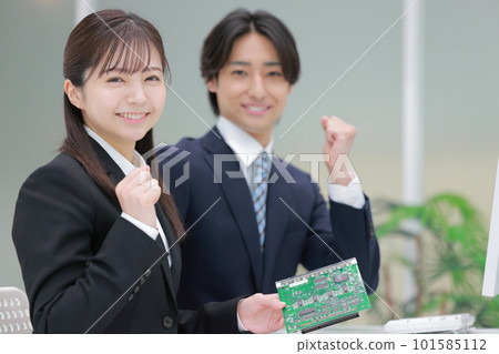 Engineer men and women holding a board and posing guts 1 101585112