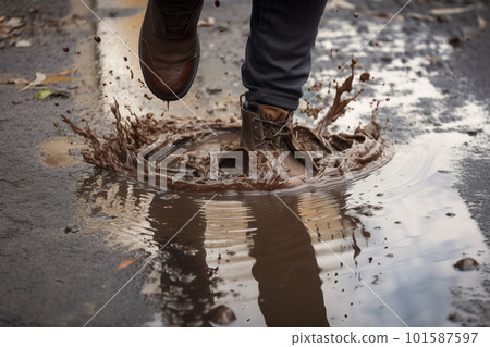 Man jumping in a puddle, splashes of dirty water. High angle view, only legs visible. AI generative image Man jumping in a puddle, splashes of dirty water. High angle view, only legs visible. AI generative image 101587597