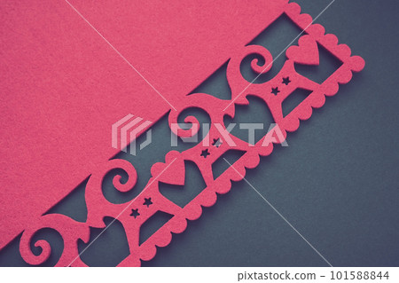 Background New Year's or for Valentine's Day. Kissing goats with stars and hearts are carved on red felt fabric. Merry Christmas and Happy New Year. Postcard, congratulation or invitation. Copy space 101588844