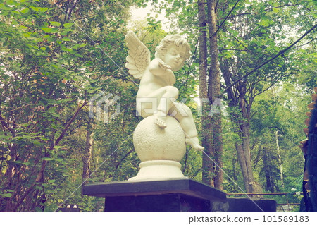 Angel in the cemetery monument at the grave of a child sculpture in the form of an angel 101589183