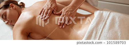 Charming woman receiving professional massage in spa salon 101589703