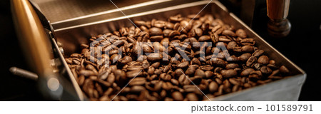 Industrial coffee roasting machine with brown coffee beans Industrial coffee roasting machine with brown coffee beans 101589791