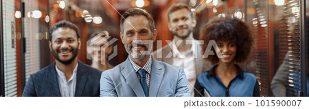 Group of happy, motivated business people standing together at office with their leader 101590007