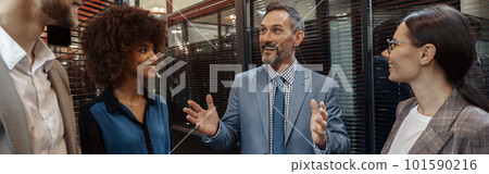 Multiethnic group of business people talking in office during break. Teamwork concept Multiethnic group of business people talking in office during break. Teamwork concept 101590216