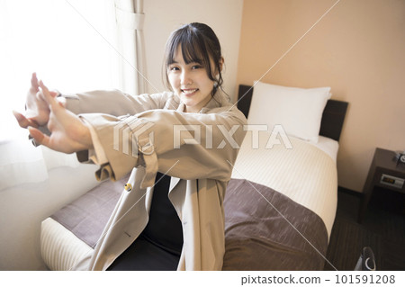 Young woman stretching after arriving at her hotel room Young woman stretching after arriving at her hotel room 101591208