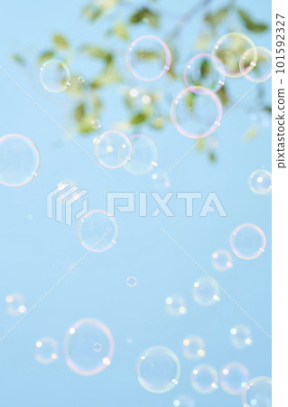 Soap bubbles dancing in the blue sky 101592327