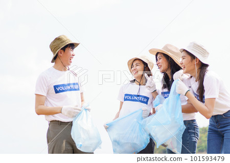 Group of Asian young people volunteer helping to collecting or picking up a plastic bottle garbage on the ground in park. Sustainability and environment conservation concept. 101593479