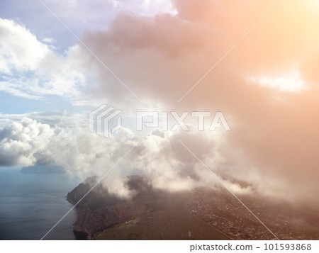 Aerial view. The drone flies over foggy and fluffy clouds. Blue sky sun and sea fog. Abstract aerial nature summer ocean sunset sea and sky background. Horizon. Vacation, travel and holiday concept Aerial view. The drone flies over foggy and fluffy clouds. Blue sky sun and sea fog. Abstract aerial nature summer ocean sunset sea and sky background. Horizon. Vacation, travel and holiday concept 101593868