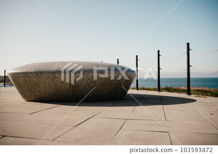 Sea side public park with concreate bench in spring evening. No people. City architecture. 101593872