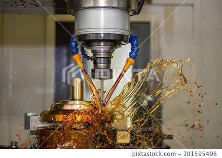 Close up scene the CNC milling machine drilling the shell mold parts with oil coolant method . 101595498