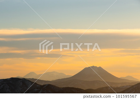 夕陽的天空和遠處朦朧的山脈 夕陽的天空和遠處朦朧的山脈 101595567