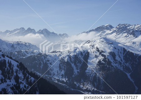 Scenic view of snow covered mountains with ski resort in front of sky on sunny day, winter holiday travel concept Scenic view of snow covered mountains with ski resort in front of sky on sunny day, winter holiday travel concept 101597127