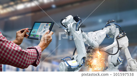 Industrial robot operator in factory holding tablet 101597538