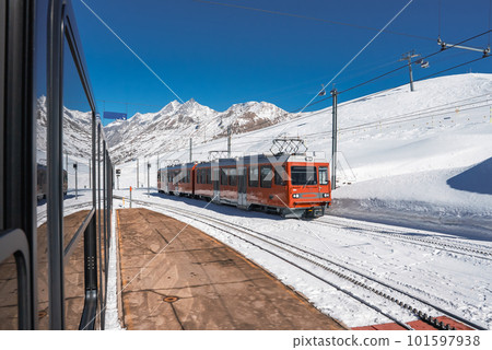 The train of Gonergratbahn running to the Gornergrat station and Stellarium Observatory - famous touristic place with clear view to Matterhorn. Glacier Express train. The train of Gonergratbahn running to the Gornergrat station and Stellarium Observatory - famous touristic place with clear view to Matterhorn. Glacier Express train. 101597938