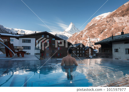 Luxury infinity outdoors pool with an amazing view at the Matterhorn peak in Zermatt, Switzerland.  101597977