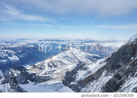 Magica view of the Alps mountains in Switzerland. View from helicopter in Swiss Alps. Mountain tops in snow. Breathtaking view of Jungfraujoch and the UNESCO World Heritage - the Aletsch Glacier 101598300