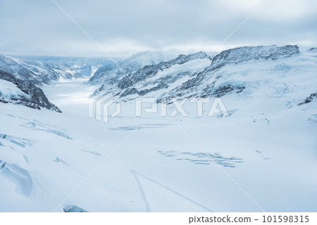 Magica view of the Alps mountains in Switzerland. View from helicopter in Swiss Alps. Mountain tops in snow. Breathtaking view of Jungfraujoch and the UNESCO World Heritage - the Aletsch Glacier Magica view of the Alps mountains in Switzerland. View from helicopter in Swiss Alps. Mountain tops in snow. Breathtaking view of Jungfraujoch and the UNESCO World Heritage - the Aletsch Glacier 101598315