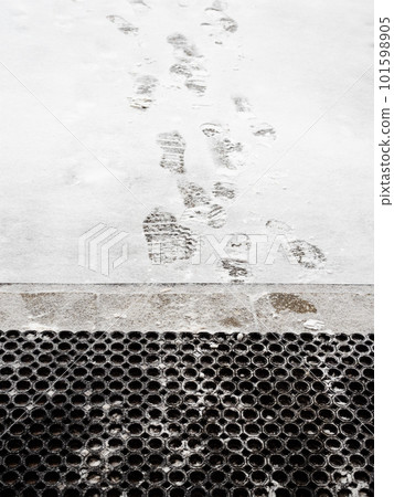 footprints on freshly fallen snow near porch footprints on freshly fallen snow near porch 101598905