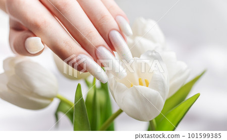 Female hand with spring nail design. 101599385