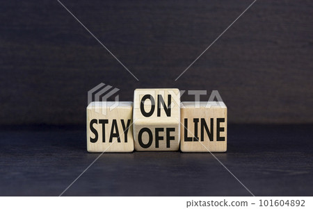 Stay online or offline symbol. Concept word Stay online or offline on wooden cubes. Beautiful black table black background. Business and stay online or offline concept. Copy space. Stay online or offline symbol. Concept word Stay online or offline on wooden cubes. Beautiful black table black background. Business and stay online or offline concept. Copy space. 101604892