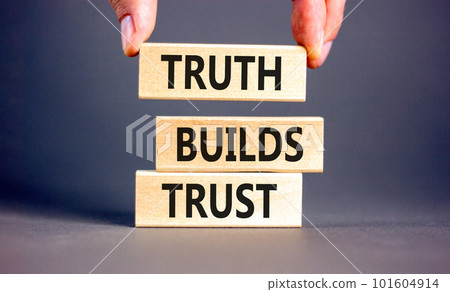 Truth builds trust symbol. Concept words Truth builds trust on wooden blocks on a beautiful grey table grey background. Businessman hand. Business truth builds trust concept. Copy space. Truth builds trust symbol. Concept words Truth builds trust on wooden blocks on a beautiful grey table grey background. Businessman hand. Business truth builds trust concept. Copy space. 101604914