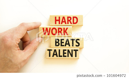 Hard work beats talent symbol. Concept words Hard work beats talent on wooden block. Beautiful white table white background. Motivational business hard work beats talent concept. Copy space. Hard work beats talent symbol. Concept words Hard work beats talent on wooden block. Beautiful white table white background. Motivational business hard work beats talent concept. Copy space. 101604972