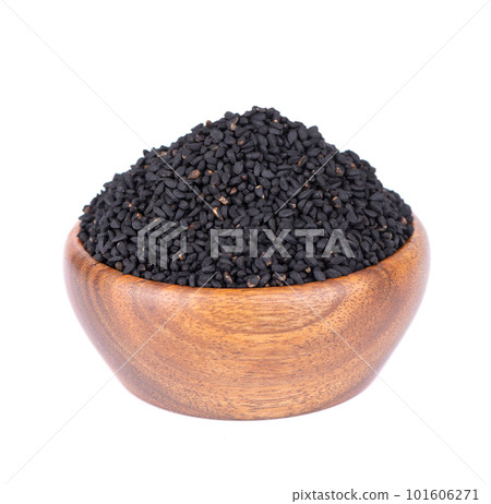 Black cumin seeds in wooden bowl, isolated on white background. Heap of black nigella seeds. Nigella sativa. 101606271