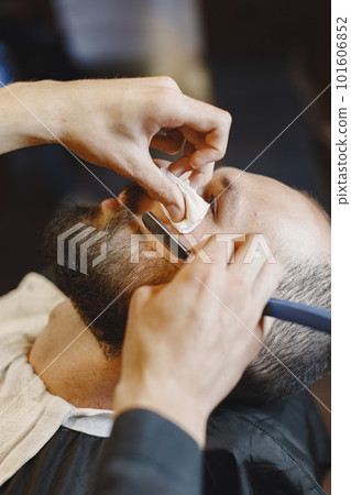 Man with a beard. Hairdresser with a client. Man with a shave. 101606852